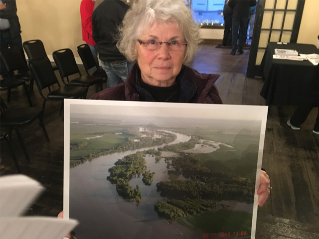 Tekamah, Nebraska, farmer Donette Jackson holds a picture of the Missouri River flooding near her land. (Photo by Todd Neeley) 